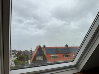 Fototapeta na wymiar Window with water droplets on rainy day, closeup