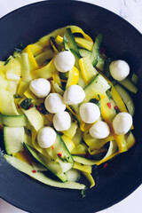 Healthy salad with fresh zucchini, mini mozzarella balls and hot chilli pepper