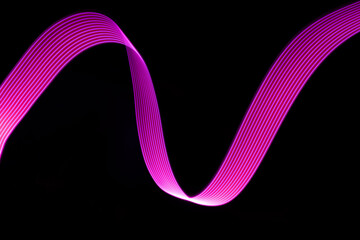 Pink and purple glow neon wave of light with smooth stripes on black background. Abstract...