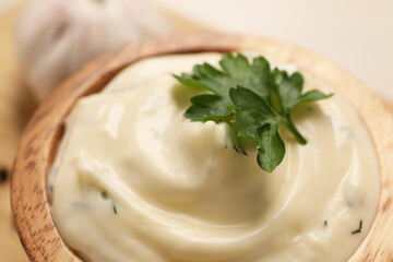 Tasty sauce with garlic and parsley in bowl, closeup