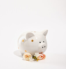 Beautiful piggy bank and summer chic flowers. Money saving and deposit investment.
