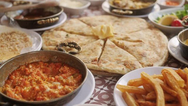 Traditional turkish breakfast, fresh cheese, olive butter and honey, jam, dessert, turkish tea, juice,