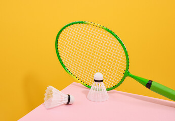 Green badminton racket and white shuttlecocks. Play and sport.