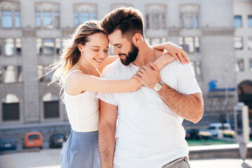 Smiling beautiful woman and her handsome boyfriend. Woman in casual summer clothes. Happy cheerful family. Female having fun. Couple posing in street at sunny day. Having tender moments