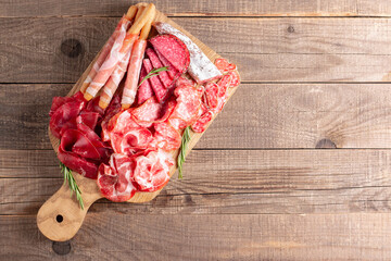 Charcuterie board. Antipasti appetizers of meat platter with salami, prosciutto crudo or jamon and olives.