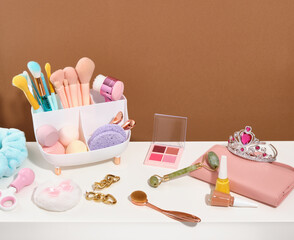 Fashion and beauty blogging concept. Various brushes for beautiful trendy makeup, colorful eye shadow, cosmetic sponges, nails polish, manicure or pedicure scissors.