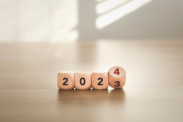 Start of the new year 2024. Flip wooden blocks with words 2023 to 2024. New beginning concept....