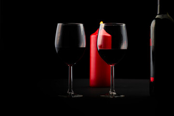 Red wine bottle, two glass of wine and candle