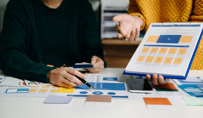  UX developer and ui designer brainstorming about mobile app interface wireframe design with...