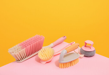 Cleaning brushes with different bristles lie on the table, an abrasive sponge for dirty surfaces.