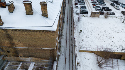 Drone photography of old prison metal and brick fence during winter