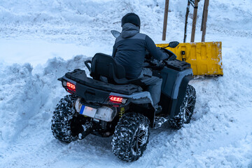 snow removal with a quad bike © talavietis