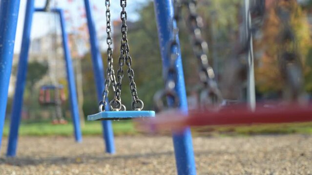 Empty swing on park playground, concept of child abduction or kidnapping