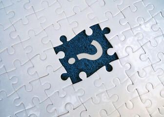 Question mark on jigsaw puzzle on blank background. Concept of question, faq, q&a, confusion and...