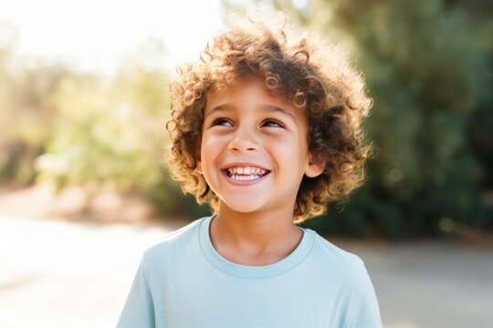 brown boy smiling. blurry background.
