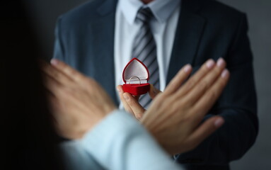 Woman refusing wedding ring in red box closeup. Wedding proposal concept