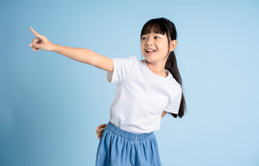 Portrait of Asian girl posing on blue background