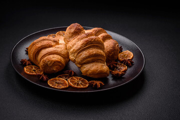 Delicious crispy baked sweet croissants with filling on a ceramic plate