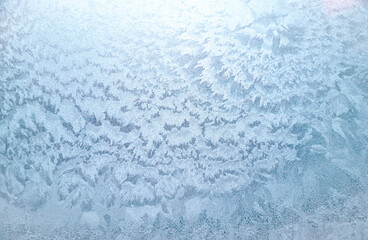 Winter window with frozen surface, icy pattern as background or texture. Abstract winter patterns snow on glass