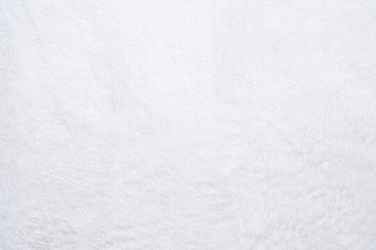 The texture of a white soft material with a high fluffy pile.