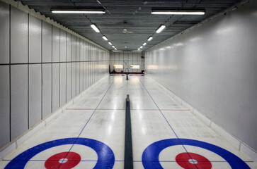 Indoor curling rink illuminated by bright lights