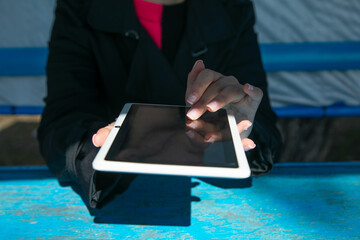 Caucasian young woman using tablet.