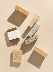 Beige and brown soap bars on light beige top view, hard shadows, packaging mockup