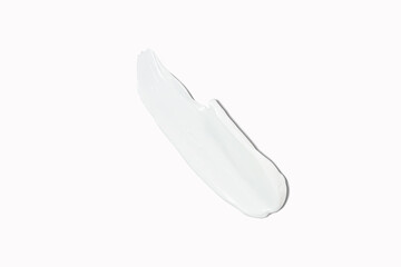 Cosmetic product smear white moisturizing lotion isolated on white, squeezed out and smeared portion of skincare cream product testing.