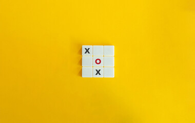 Tic-tac Toe Game. XO Strategy Concept Image. Block Letter Tiles on Yellow Background. Minimalist...