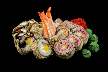 Sushi set of various sushi rolls on a black background