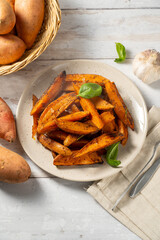 Delicious homemade sweet potato wedges, fries on a plate.