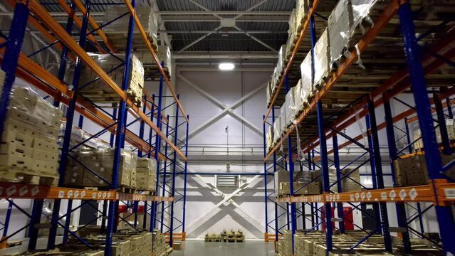 Gigantic warehouse situated in industrial zone housing diverse range of goods. Immense storage facility filled with packs prepared for shipment