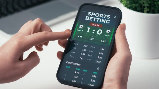 Making online bet on a gambling app. Watching live football score broadcast on a gambling smartphone application and gambling. Internet gambling concept.