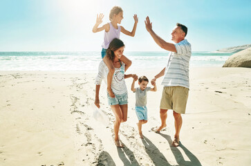 Parents, children and beach for high five happy or summer travel vacation, ocean sunshine or family...