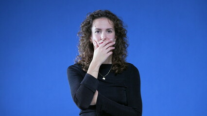 Thoughtful Woman with Sudden Insight, Eureka Epiphany on Blue background raising hand and finger in...