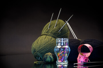 wool yarn, knitting needles and other tools for hand knitting.