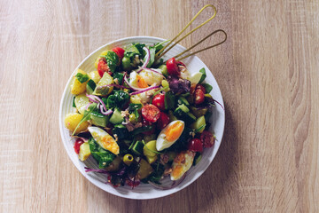 Nicoise Salad - French style salad with eggs, tuna, tomatoes, green olives, potatoes, green beans and cucumber