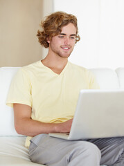 Laptop, remote work and happy man on sofa for research, planning or web communication in his home. Tech, freelance and male entrepreneur online in living room with social media, search or streaming