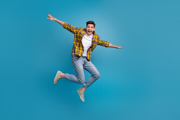 Obraz premium Full body size photo of carefree flying guy enjoying free time spending alone in park wings hands isolated on blue color background