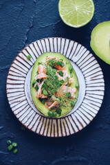 Healthy salad with avocado, smoked salmon, green onion and dill