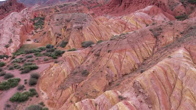 aerial view, drone shot, red sandstone formation, iron-rich minerals in the sand break down and the iron is oxidized, hematite crystals, compacted and cemented together over millions of years.
