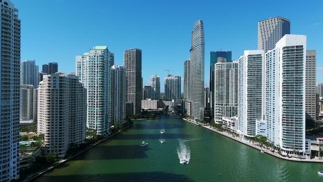 City skyline with tall buildings and skyscrapers. Miami River divided downtown on two neighborhoods. Blue sky providing beautiful backdrop to urban landscape
