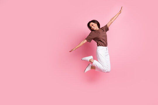 Full body length photo of flying in air traveling enjoyer charming carefree girl having fun positive isolated over pink color background