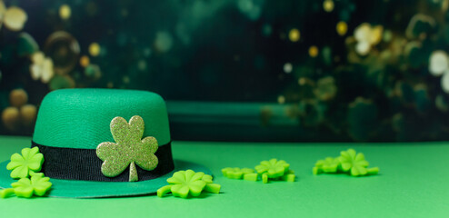 Shamrocks and leprechaun hats on green background with Copy space.