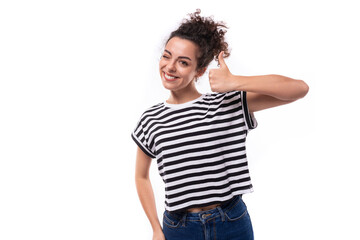 young positive curly brunette woman in a black and white striped casual t-shirt