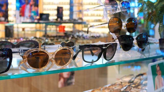 Cinematic video: sunglasses on display in a store. Slow motion of sunglasses on display in a store. Concept: Buy sunglasses from the store to protect your eyes from the bright sun on holiday in summer