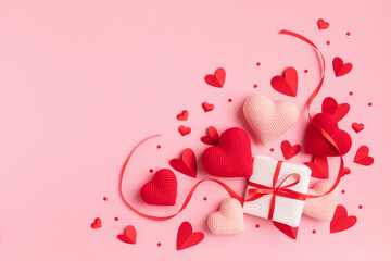 Valentine or mother day festive composition with gift or present box and red hearts on pastel pink background top view. Flat lay greeting card. - 692516546
