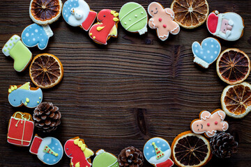 Christmas cookies in the shape of a dragons and New Years decoration with candied oranges