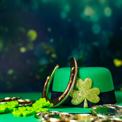 Traditional symbols for Patrick's Day, green leprechaun hat, horseshoe and clover.