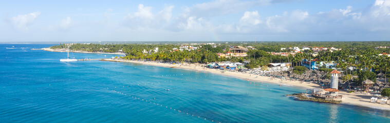Dominicus beach at Bayahibe with Caribbean sea sandy seashore, lighthouse and pier. Aerial view....